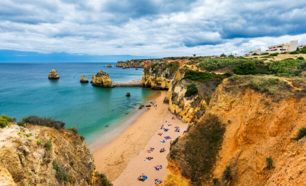Praia Dona Ana beach with turquoise sea water and cliffs, Portugal. Beautiful Dona Ana Beach (Praia Dona Ana) in Lagos, Algarve, Portugal.
